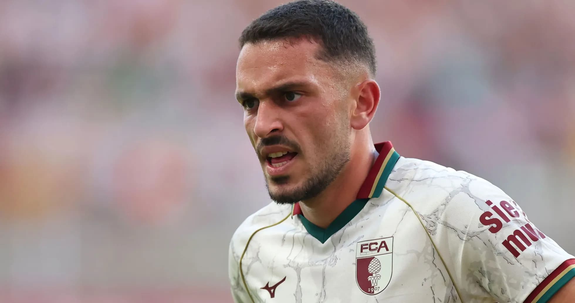 Player in FC Augsburg kit during match action
