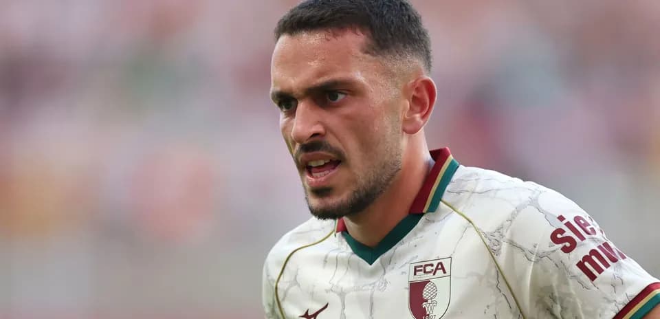 Player in FC Augsburg kit during match action