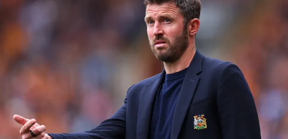 Coach gesturing during a football match on sideline
