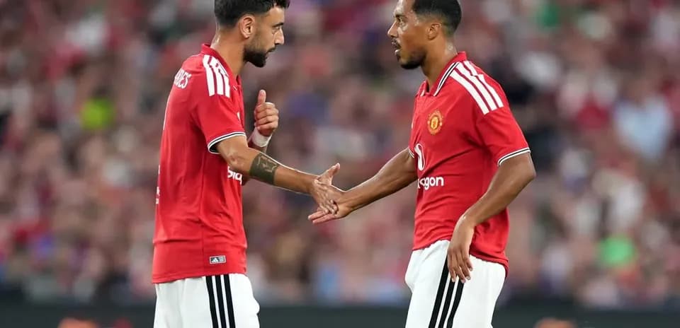 Two Manchester United players discussing on the pitch