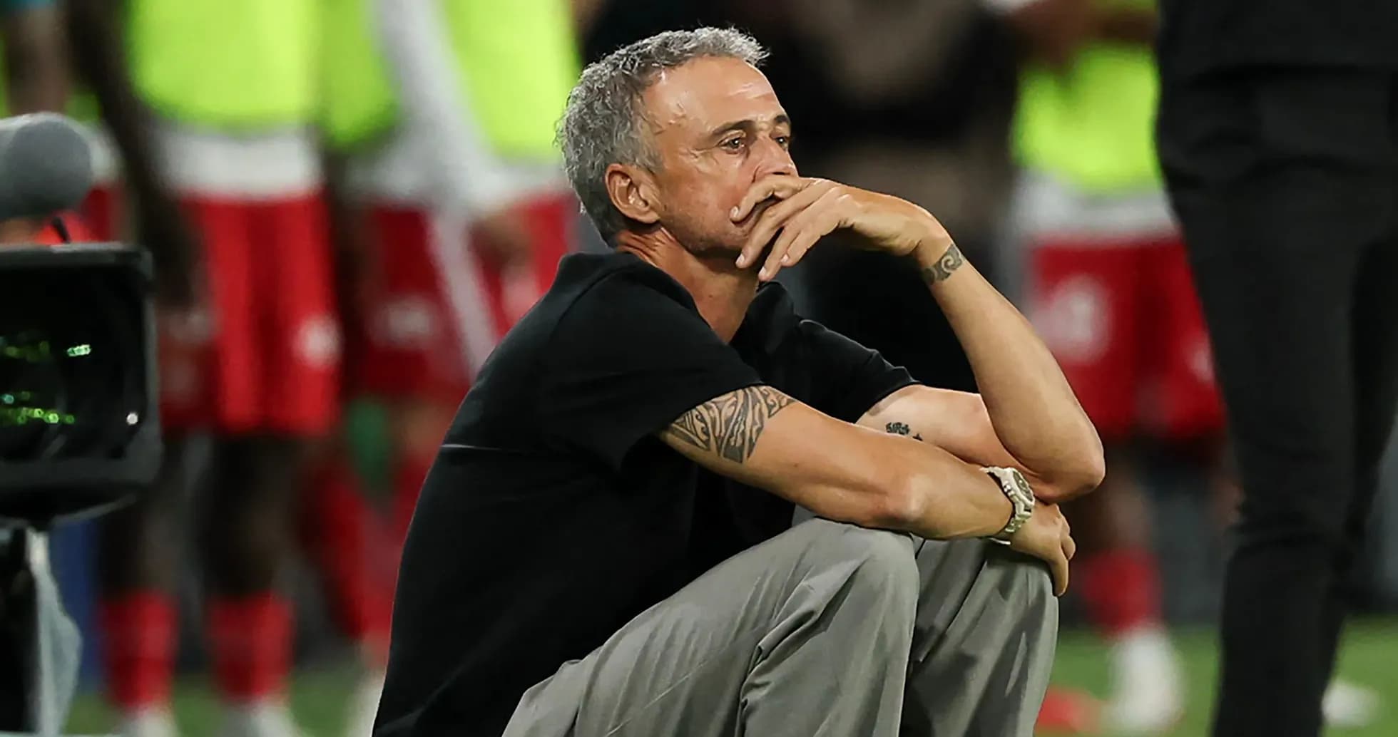 Coach sitting on the sidelines during match