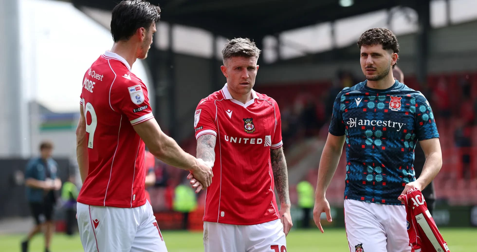 Three players shaking hands after a match
