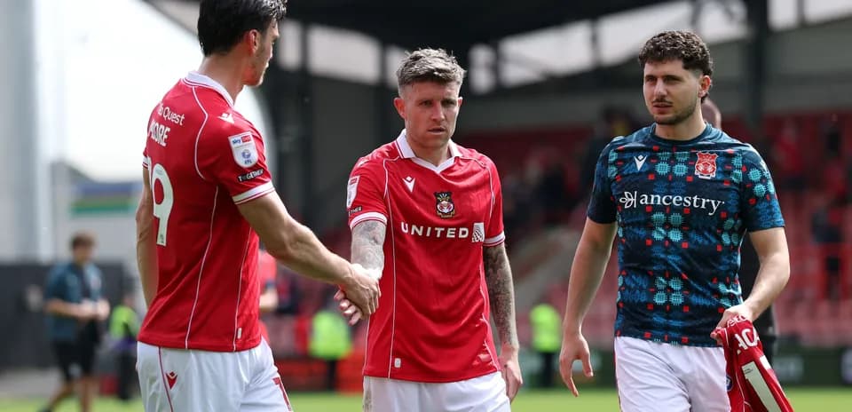 Three players shaking hands after a match