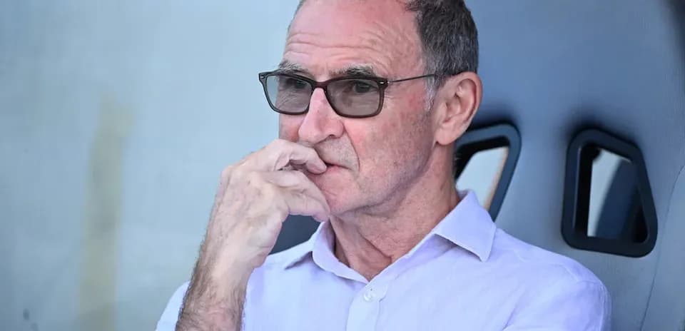 Man in glasses sitting on team bench