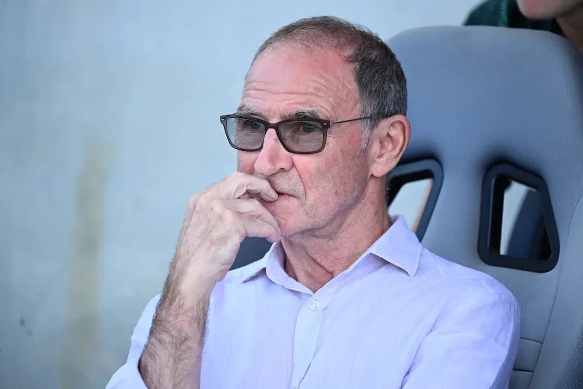 Man in glasses sitting on team bench