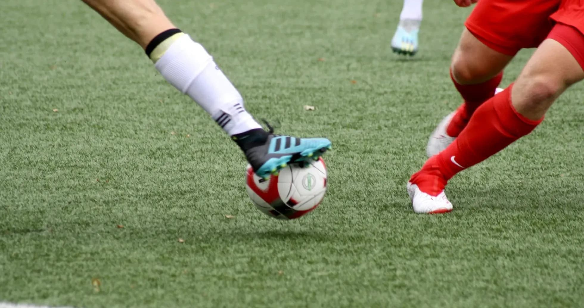 Players competing for the ball in football match
