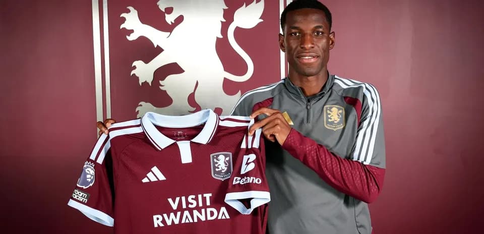 Player holding Aston Villa jersey during announcement