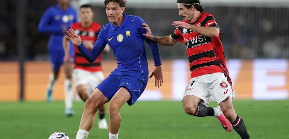 Player in blue evading a tackle from opponent in red