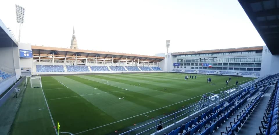 View of stadium with players training on pitch