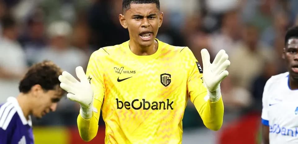 Goalkeeper in yellow kit directing teammates during match