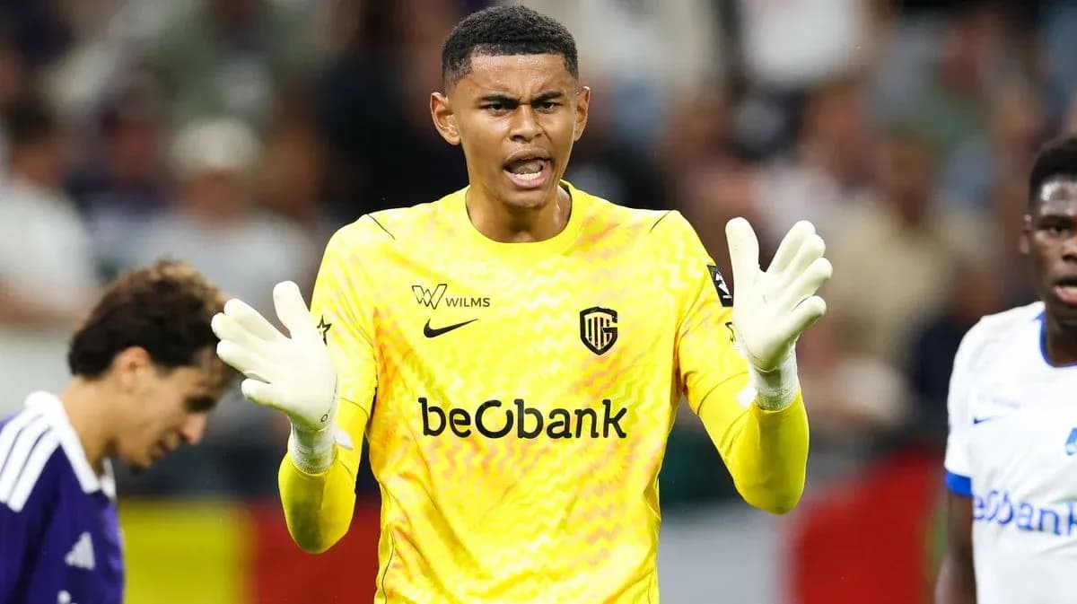 Goalkeeper in yellow kit directing teammates during match