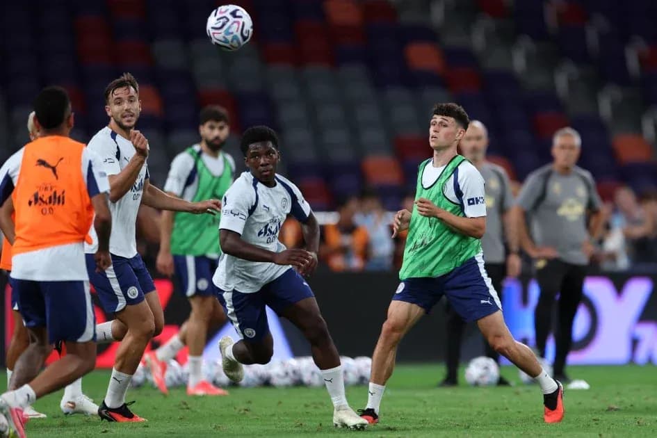 Players training and passing the ball on field