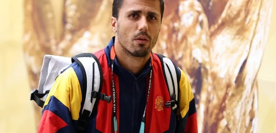 Athlete wearing team jacket and backpack indoors