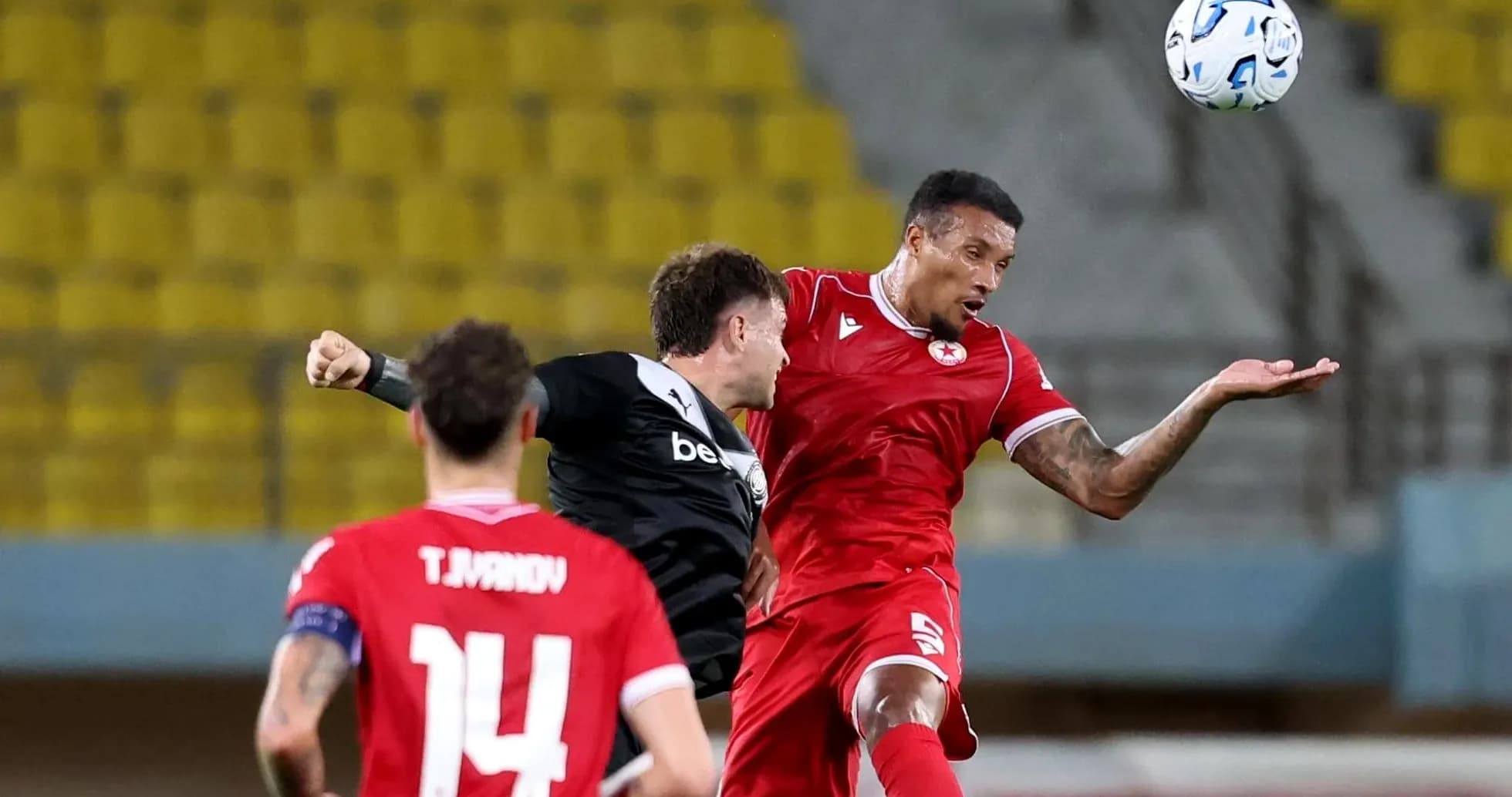 Players competing for the ball during Europa League match