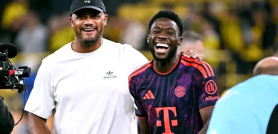 Two men laughing on the football pitch