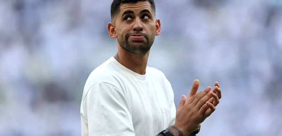 Player applauding in a stadium with fans