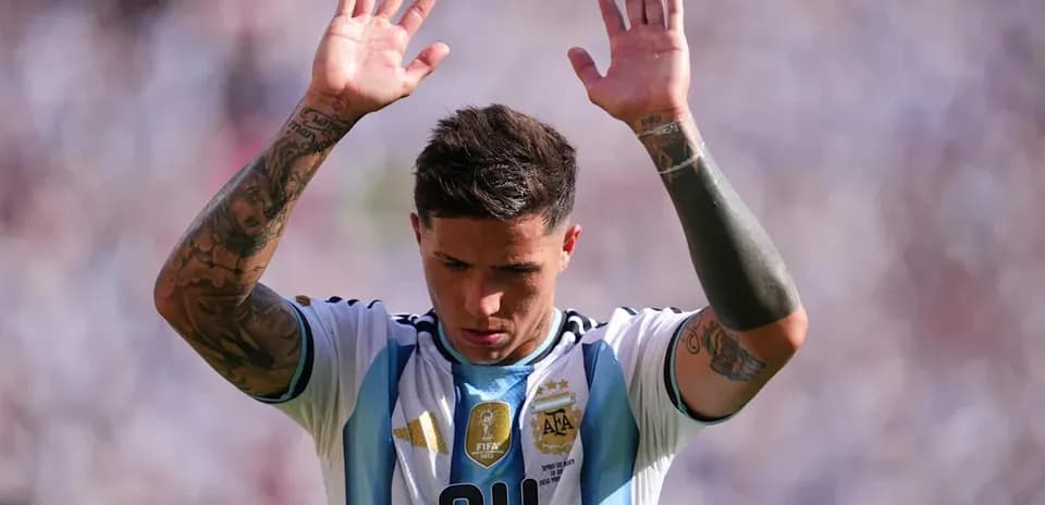 Player in Argentina kit raising hands during match