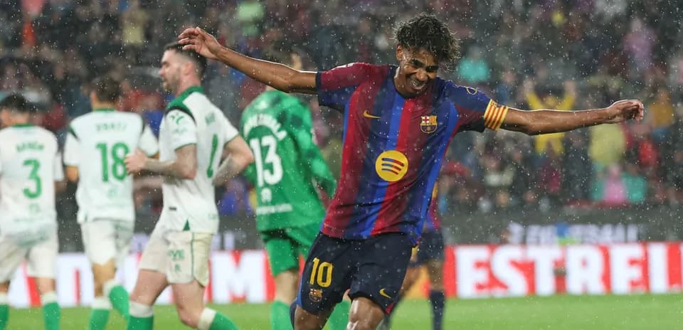 Barcelona player celebrating goal in heavy rain