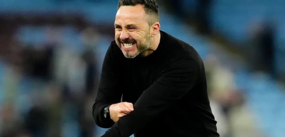 Coach celebrating passionately on the sidelines