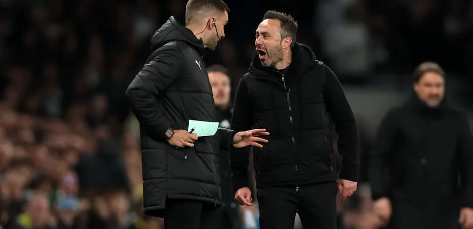 Coaches discussing during a tense moment on the sidelines