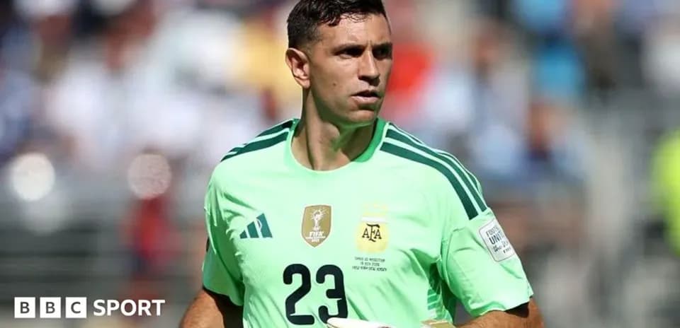 Goalkeeper in green jersey during match warm-up