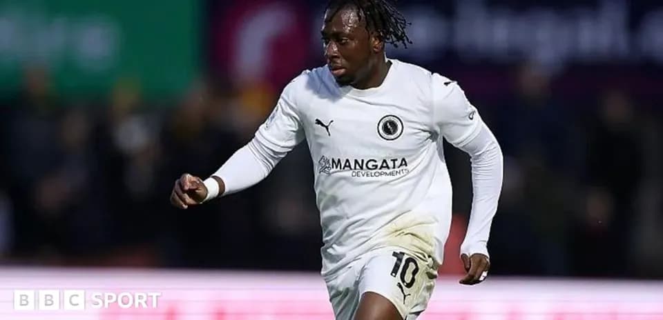 Player celebrating a goal in white team jersey