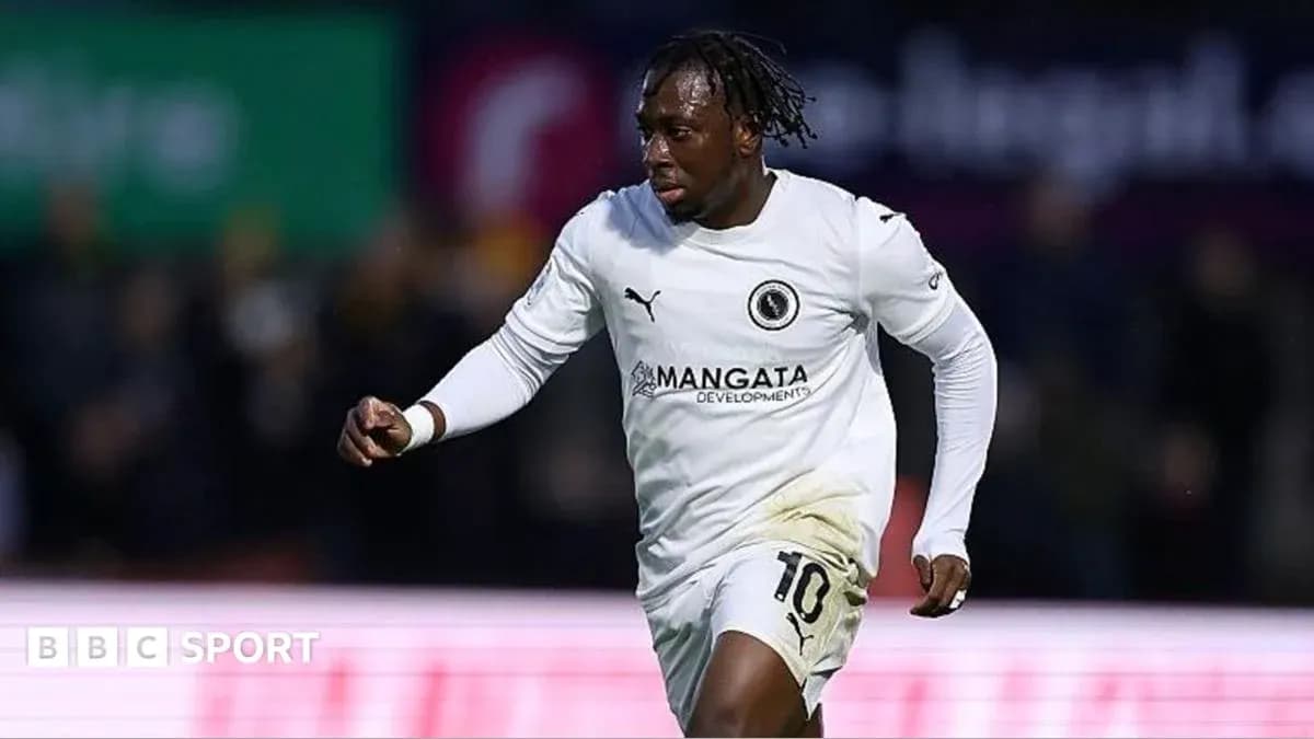 Player celebrating a goal in white team jersey