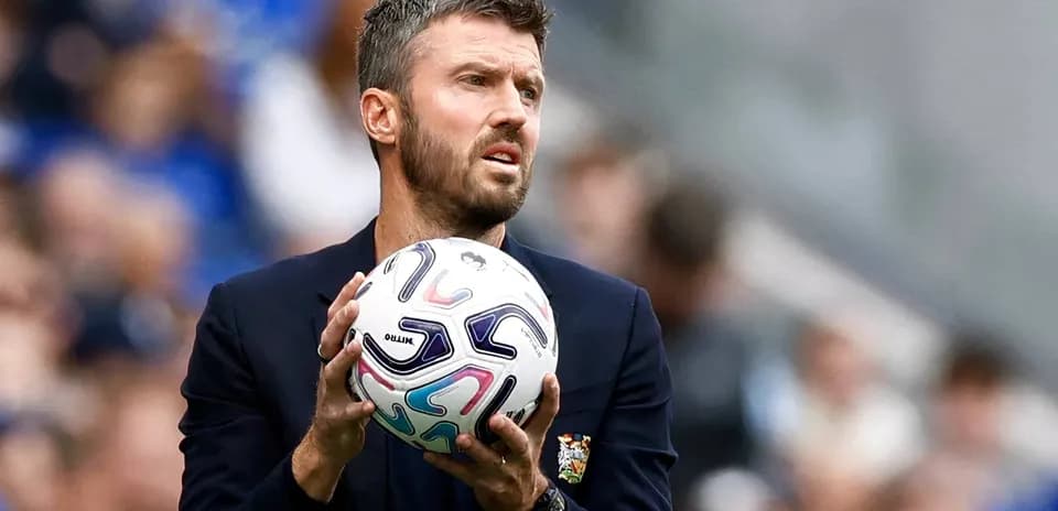 Coach holding ball during a match on the sidelines