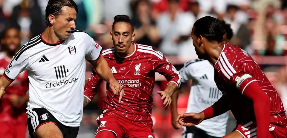 Liverpool and Fulham players competing for the ball