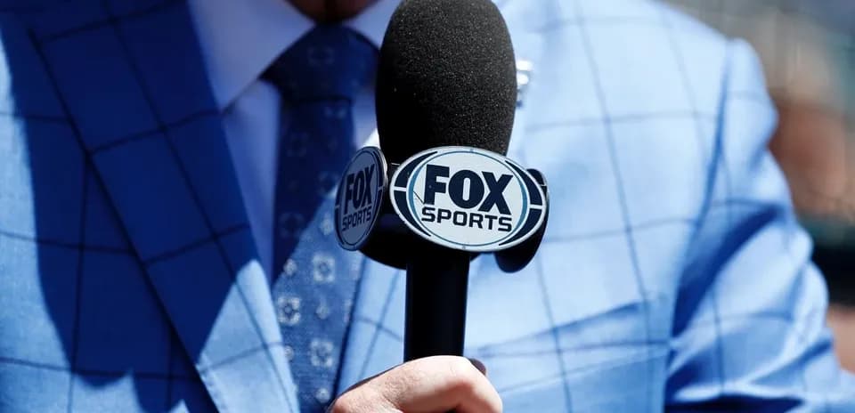 Reporter holding a FOX Sports microphone