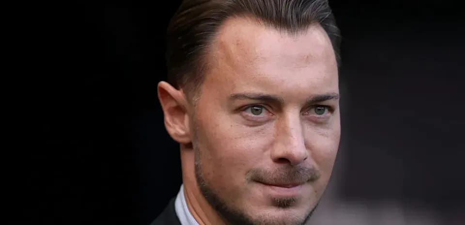 Close-up of a man in a suit looking ahead