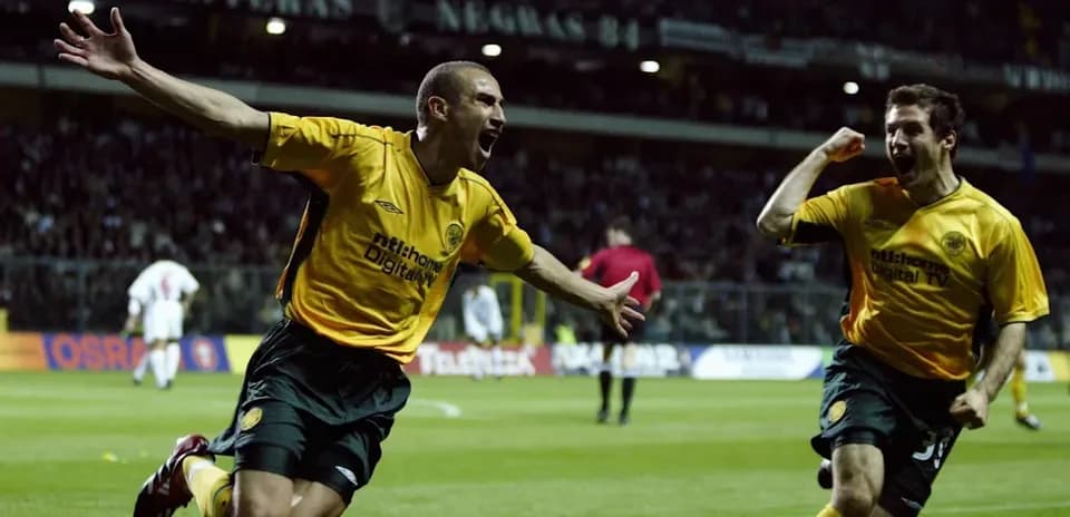 Two players celebrating a goal on the pitch