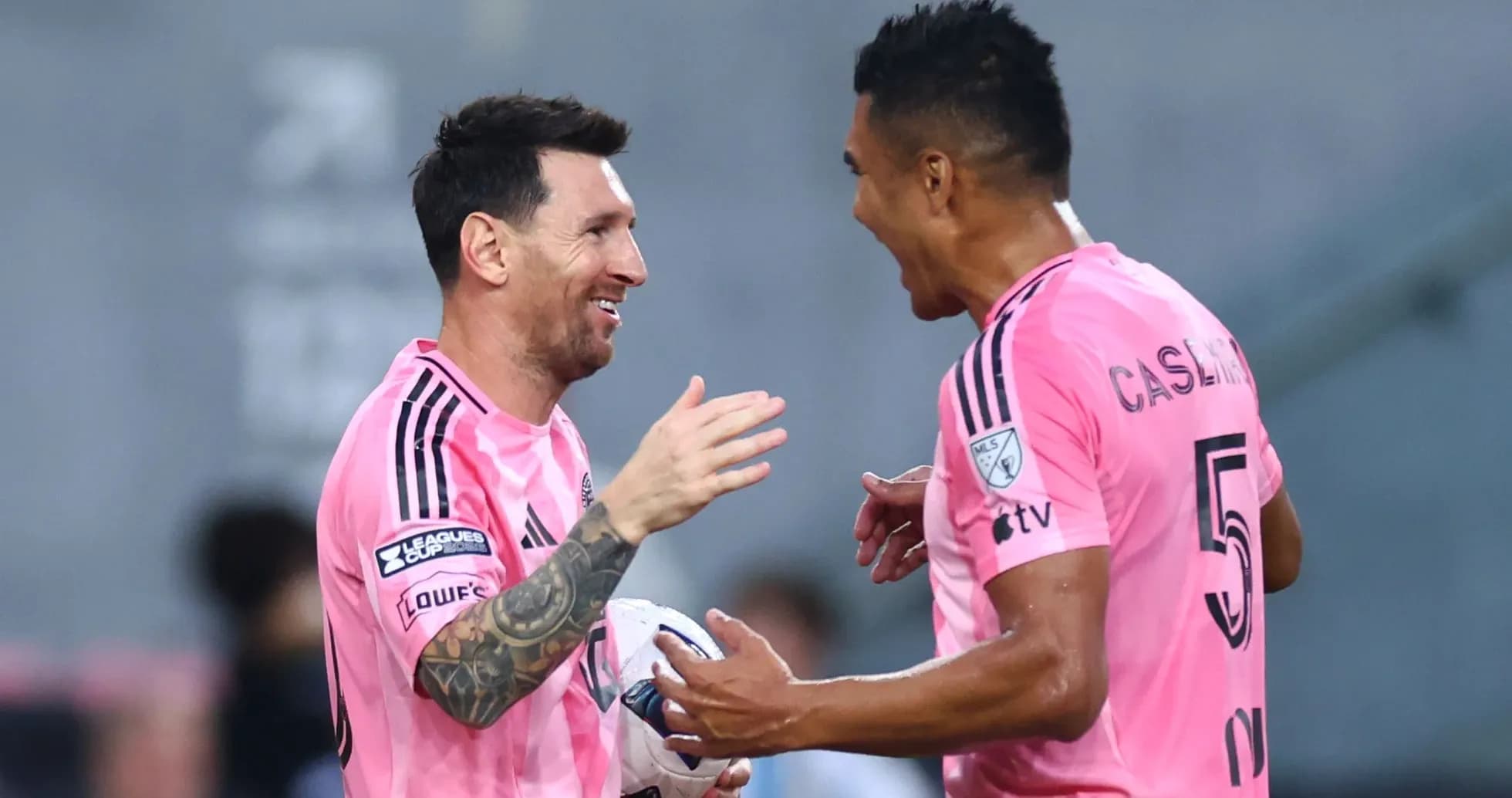 Two players celebrating a goal on the field