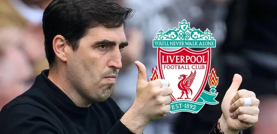 Coach giving thumbs up near Liverpool logo
