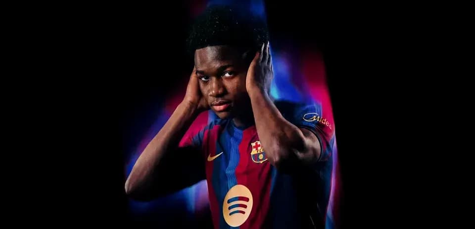 Player in Barcelona jersey posing with hands on ears