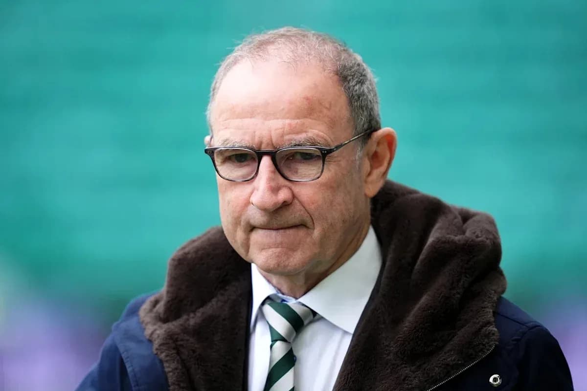 Man in glasses wearing a dark coat and tie