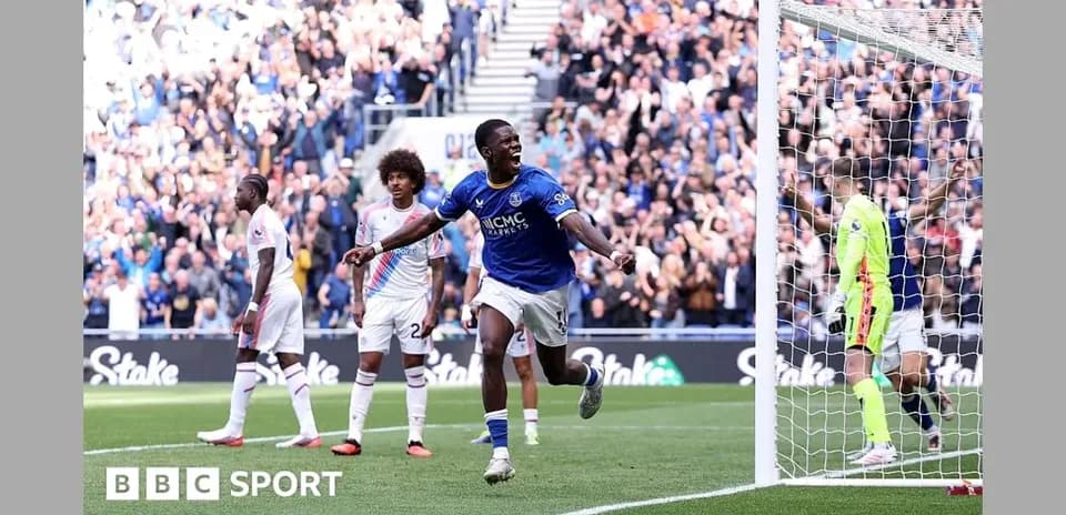 Player celebrating a goal with fans in background