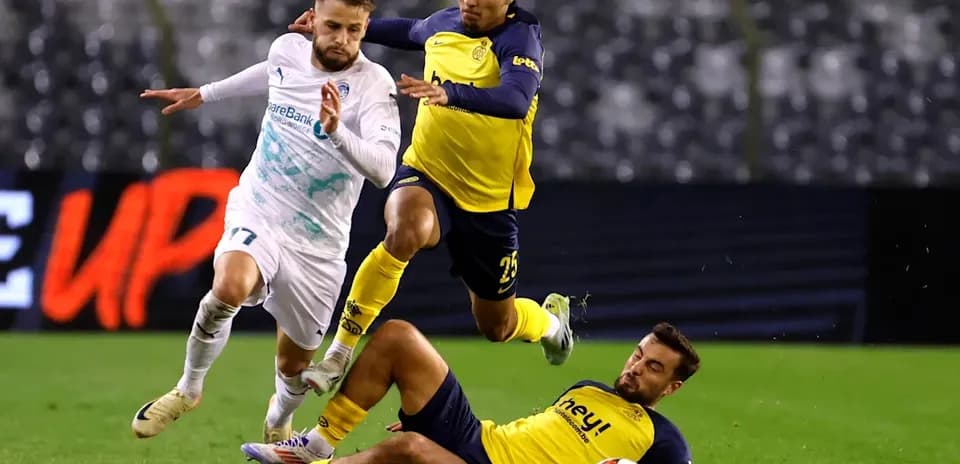 Player attempting to evade two defenders on field