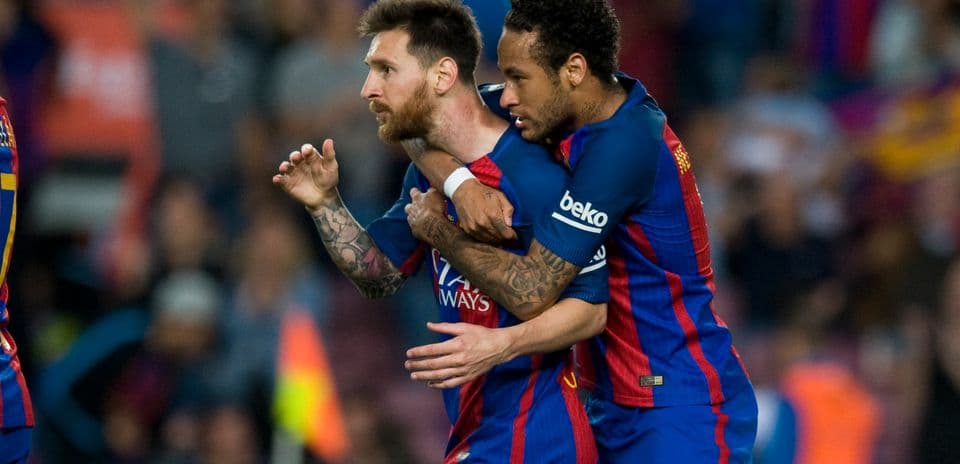 Lionel Messi celebrating with Neymar after a goal