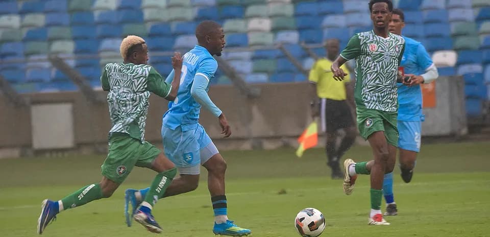 Rukinzo player dribbling past Durban City defenders