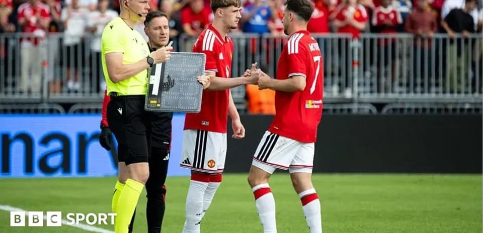 Players shaking hands during a substitution in match