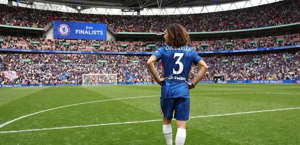 Player in Chelsea kit on pitch at Wembley Stadium