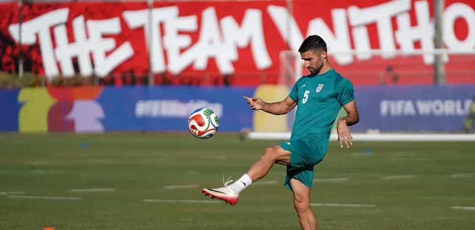 Iran player practicing with a football