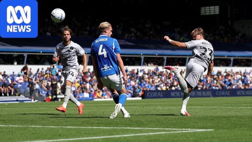 Player striking the ball during football match action