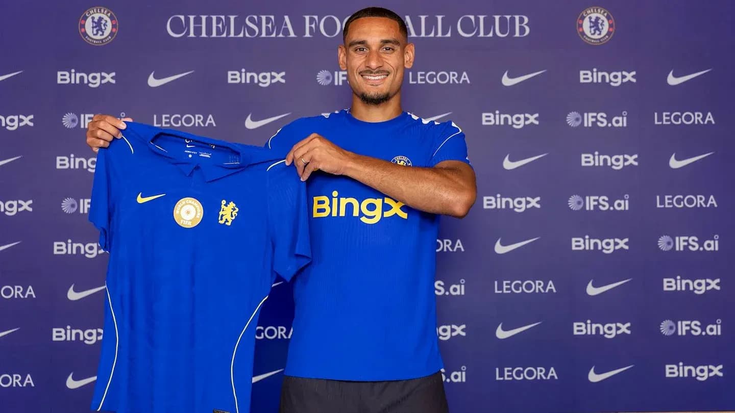 Player holding Chelsea jersey during announcement event