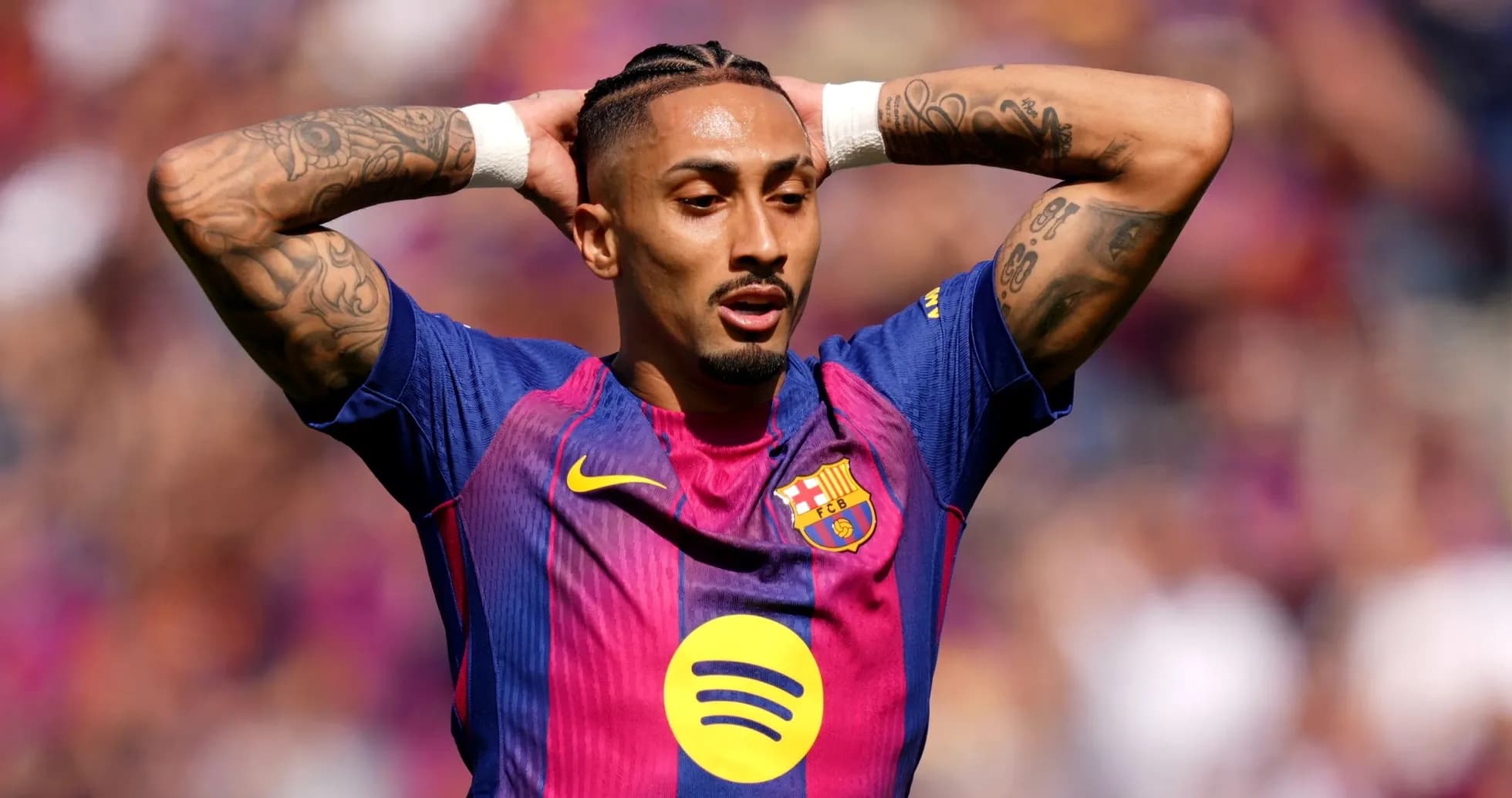 Player with tattoos expressing frustration on field