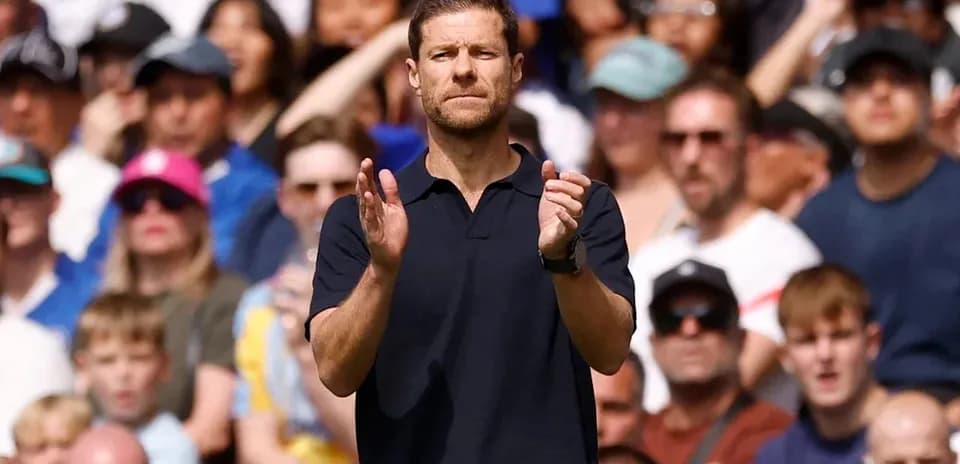 Coach applauding in front of a cheering crowd