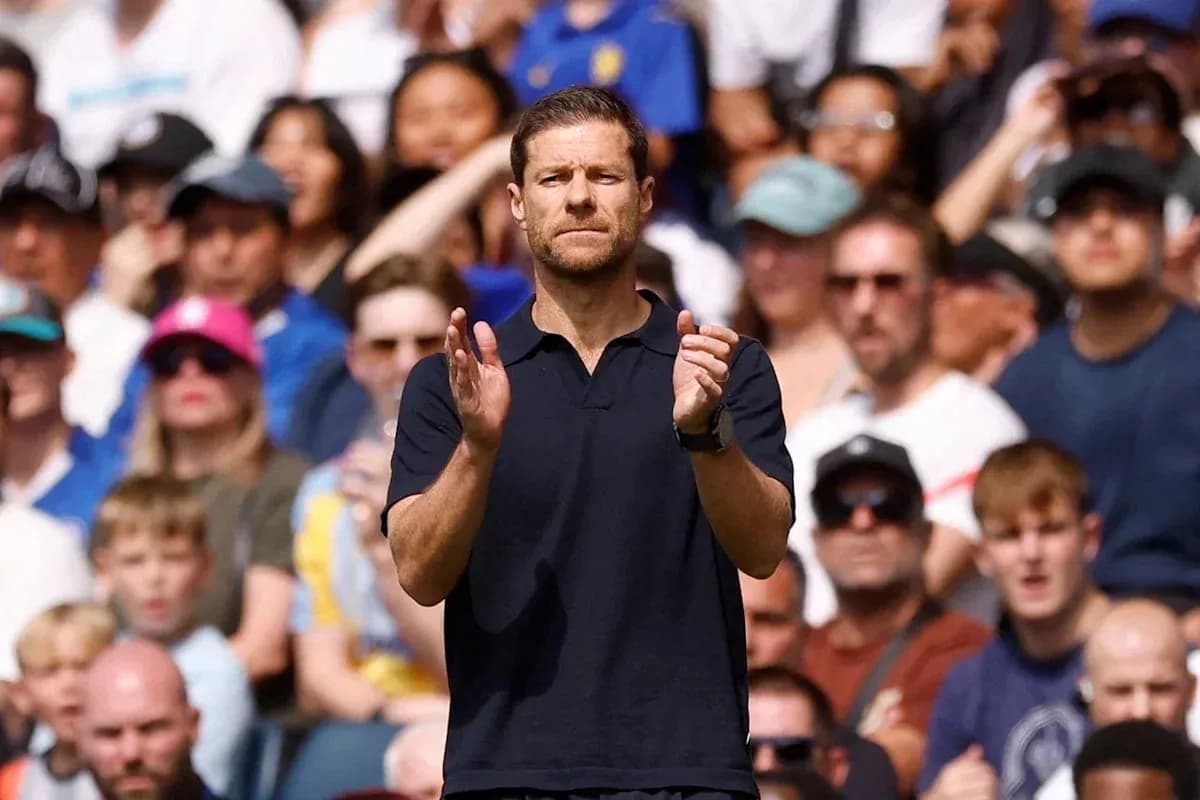 Coach applauding in front of a cheering crowd