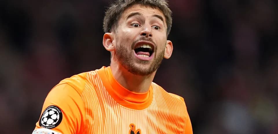 Goalkeeper in orange kit shouting during match