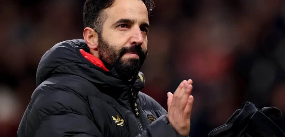 Coach applauding fans in a stadium setting